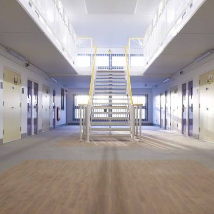 Interior shot of a prison area with staircase and cell doors