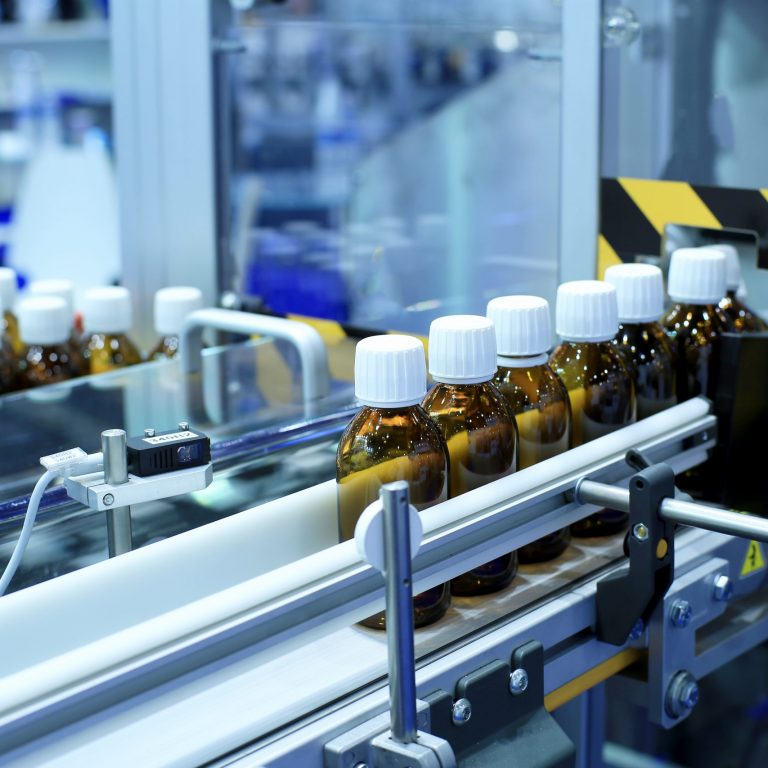 Medicine bottles in a factory machine