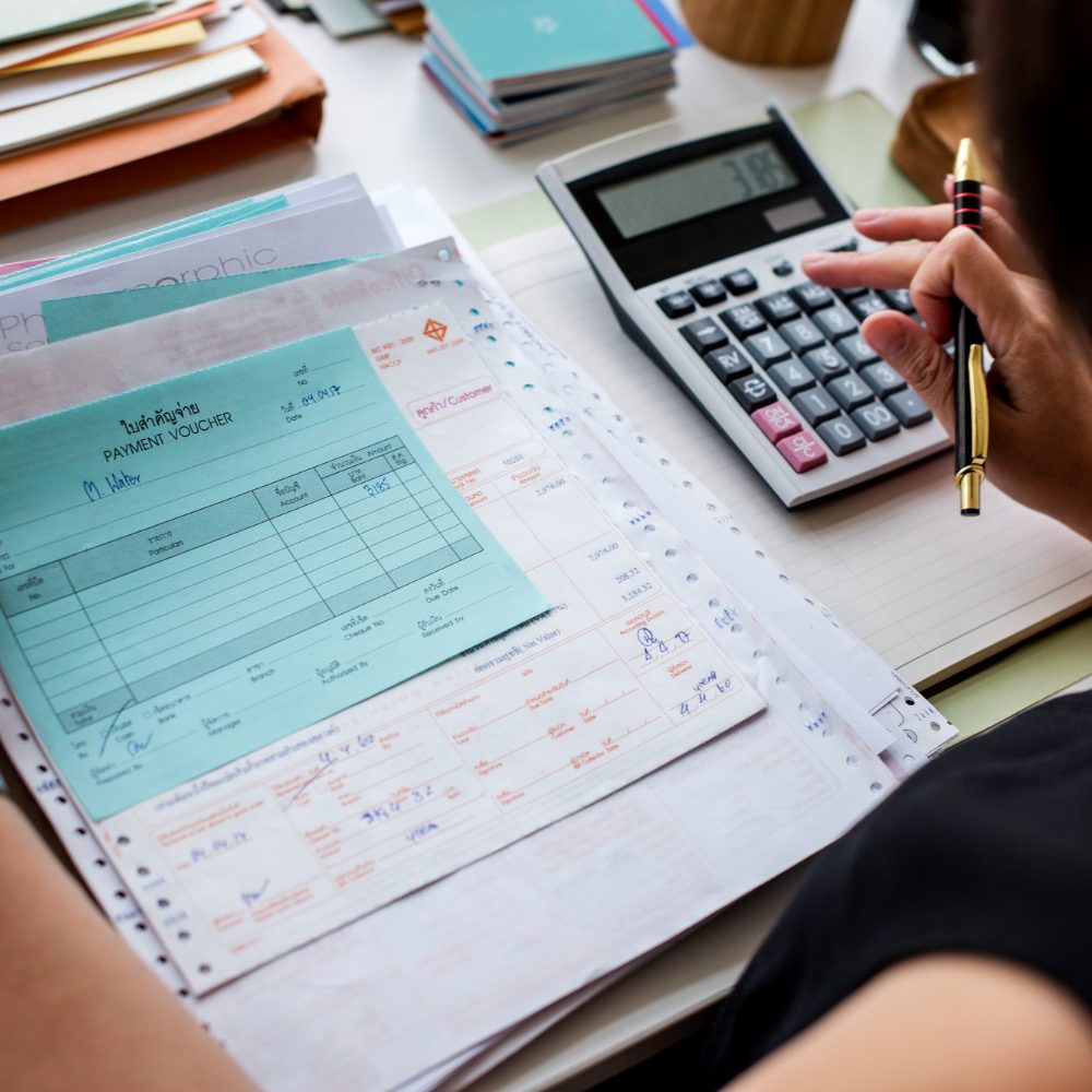 Paperwork and hand using calculator